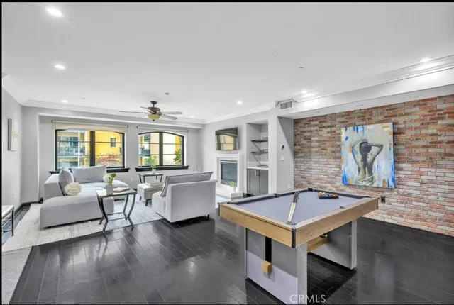 a living room with pool table furniture and a large window