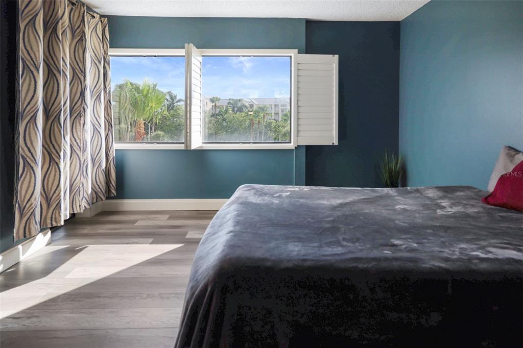 401 150th Avenue, Unit 231 Madeira Beach, FL 33708 - Photo 26 of 56 a bedroom with a bed and a window