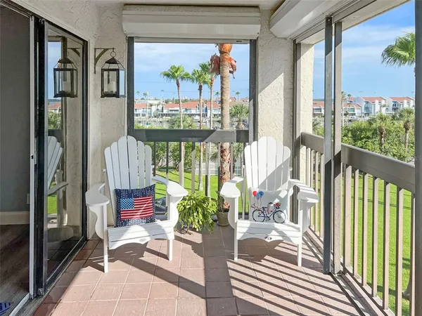 a balcony with furniture and floor to ceiling window