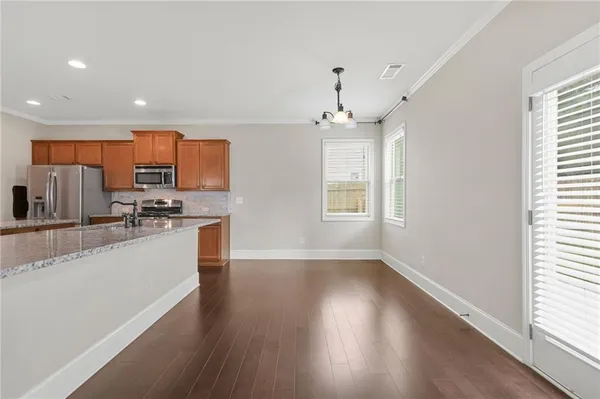 a kitchen with stainless steel appliances a refrigerator sink and microwave