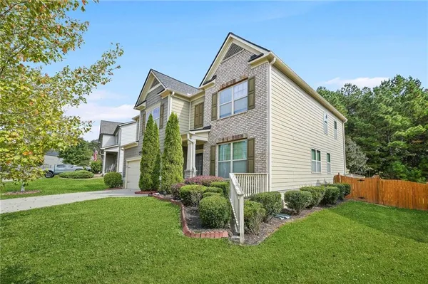 a front view of a house with a yard