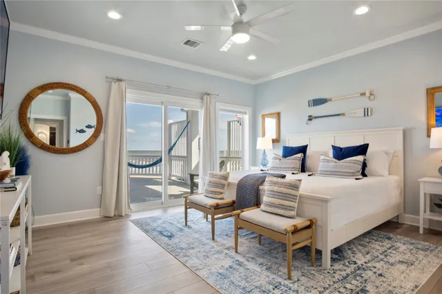 a spacious bedroom with a large bed and a chandelier