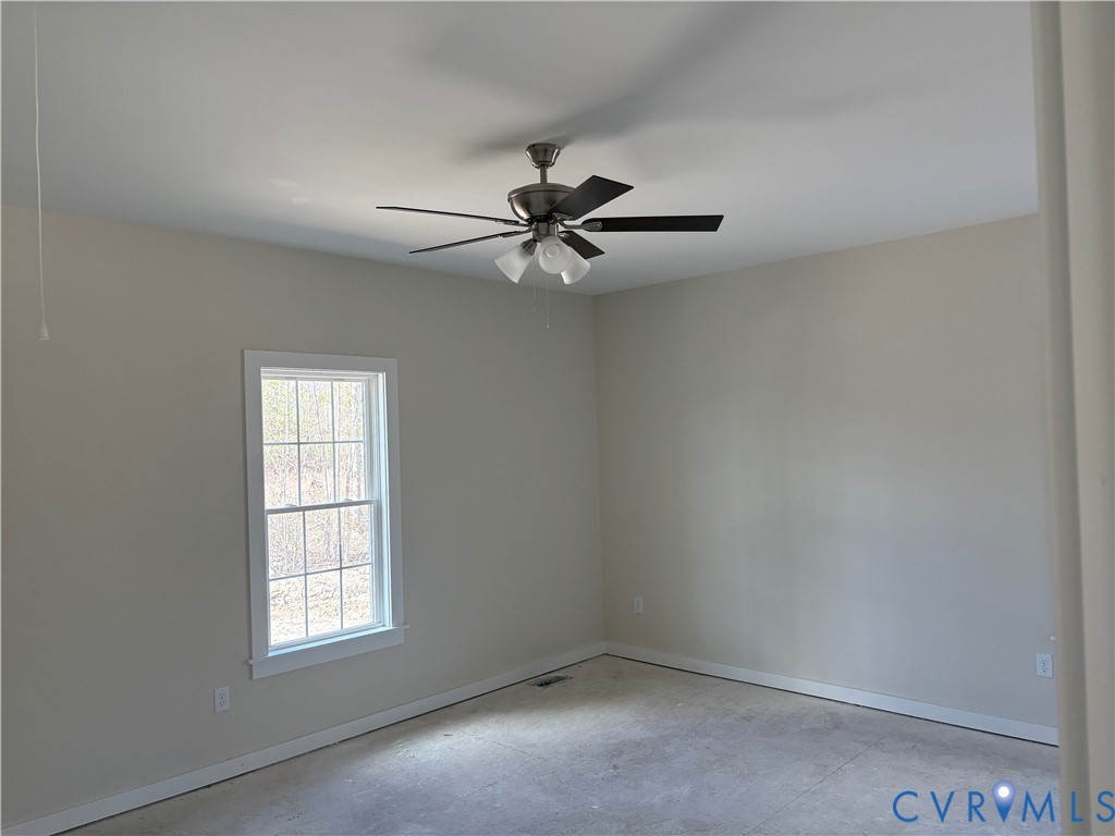 15085 Lebanon Road Disputanta, VA 23842 - Photo 13 of 17 an empty room with windows and fan