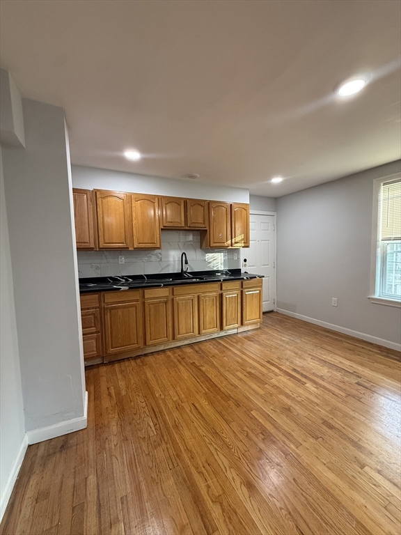 78 Hollis Street, Unit 2 Worcester, MA 01610 - Photo 2 of 8 a kitchen with stainless steel appliances granite countertop a refrigerator and a stove top oven
