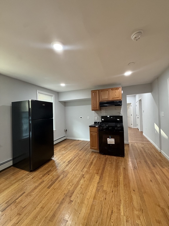 78 Hollis Street, Unit 2 Worcester, MA 01610 - Photo 3 of 8 a kitchen with stainless steel appliances a refrigerator and a stove top oven