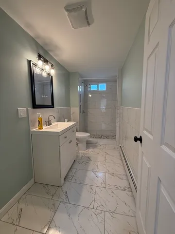 a bathroom with a sink mirror and a bathtub