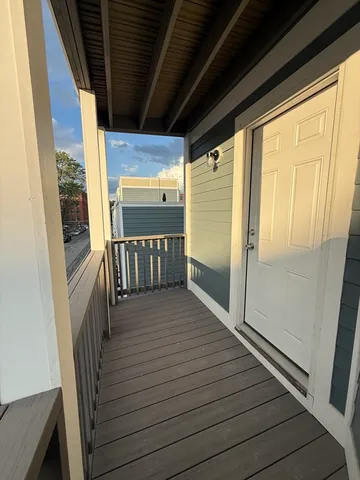 a view of a balcony with wooden floor
