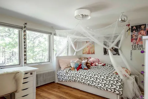 a bedroom with a bed and a window