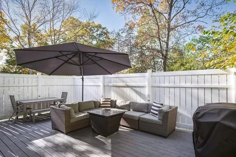 a view of a patio with couches under an umbrella