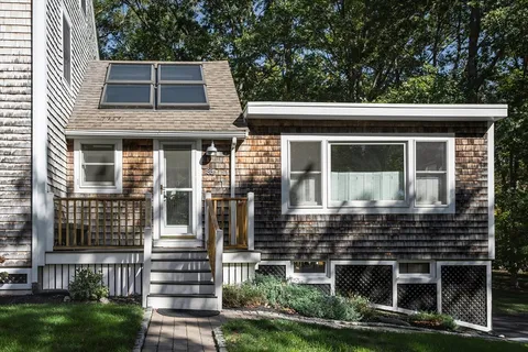 a dining room with furniture a rug and a floor to ceiling window