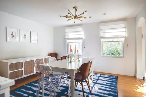 a dining room with furniture and window