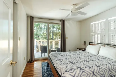 a balcony with wooden floor and outdoor seating