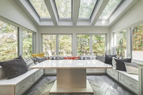 a living room with furniture and large windows