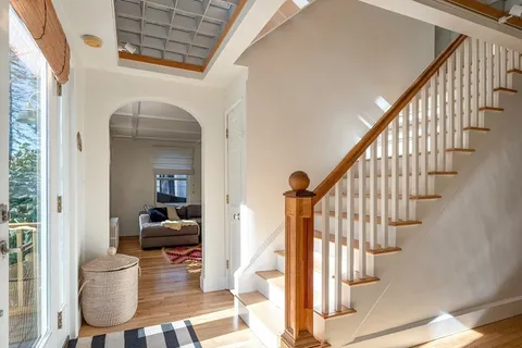 a view of entryway and hall with wooden floor