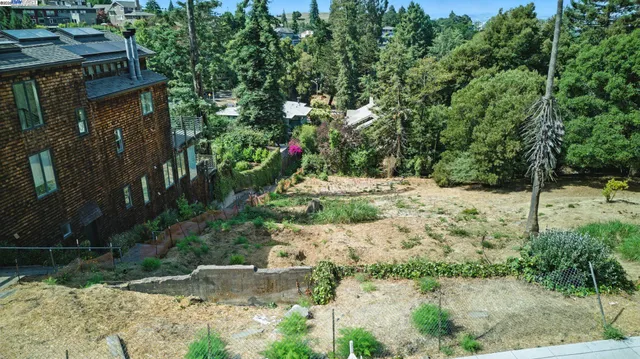 an aerial view of residential houses with yard