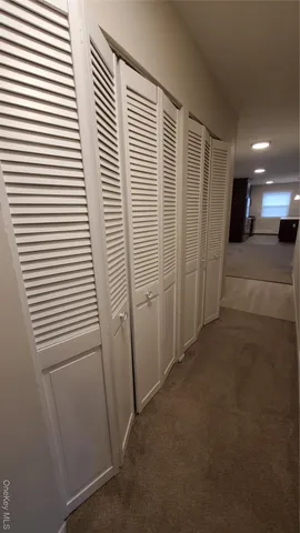 a view of a hallway to a house with stairs