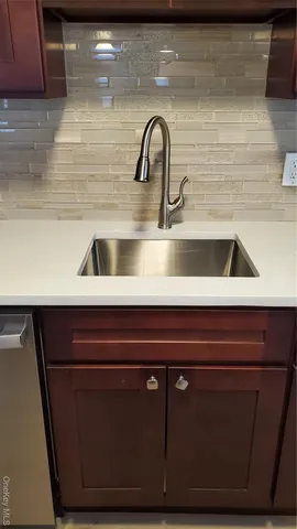 a kitchen with wooden cabinets and a stove top oven