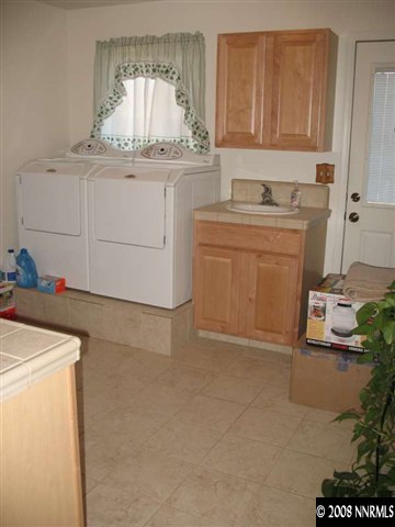 17585 Parrot Drive Reno, NV 89508 - Photo 6 of 9 a utility room with cabinets washer and dryer