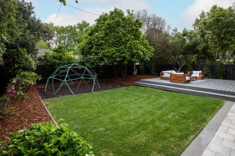 a view of a backyard with sitting area