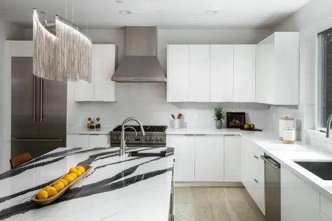 a kitchen with a sink and a stove top oven