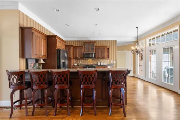 a kitchen with stainless steel appliances granite countertop a sink refrigerator and microwave