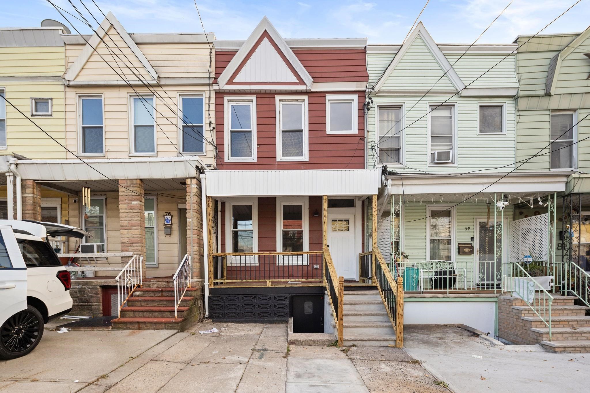 77 Boyd Avenue Jersey City, NJ 07304 - Photo 1 of 26 a front view of a building with a porch