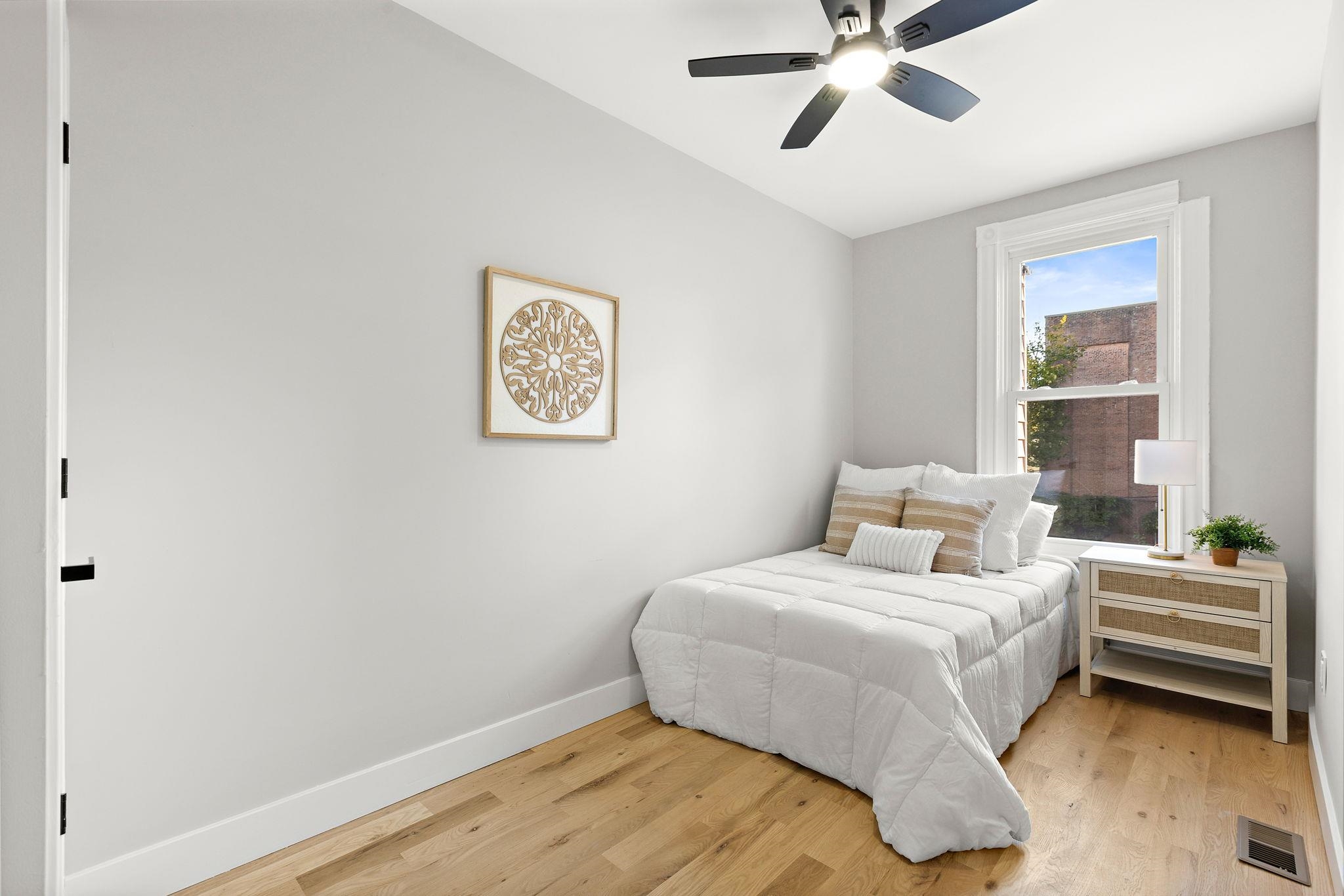 77 Boyd Avenue Jersey City, NJ 07304 - Photo 12 of 26 a bedroom with a bed and a window