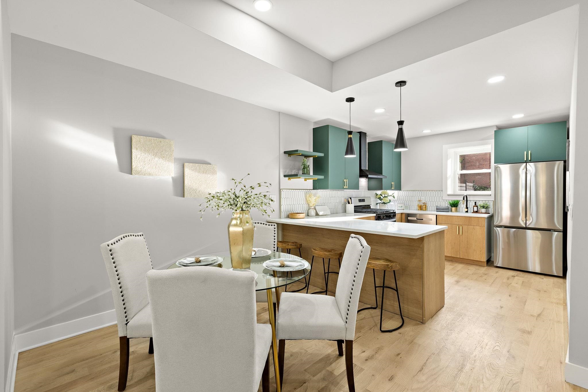 77 Boyd Avenue Jersey City, NJ 07304 - Photo 15 of 26 a dining room with kitchen island a table and chairs