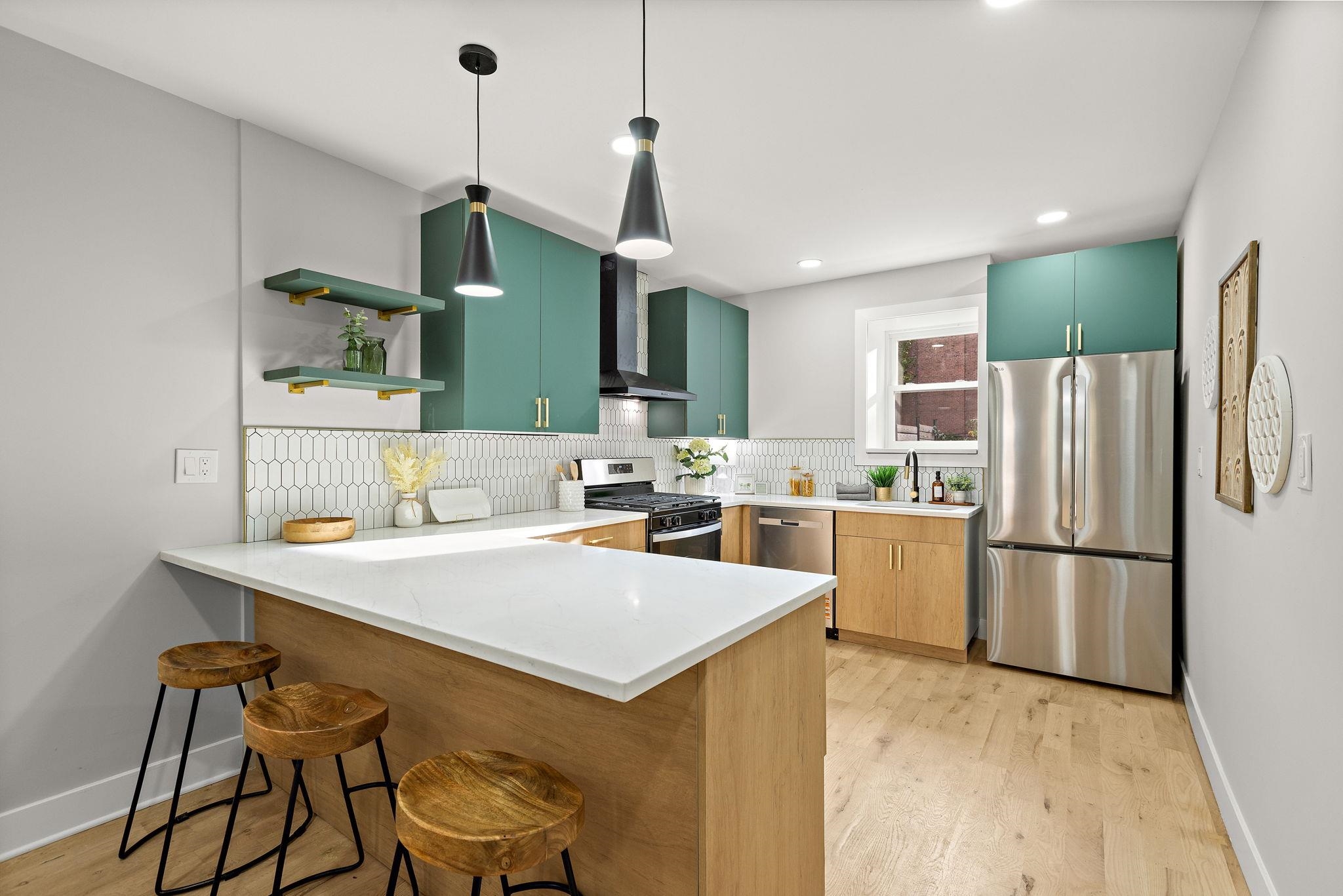 77 Boyd Avenue Jersey City, NJ 07304 - Photo 16 of 26 a kitchen with a refrigerator a stove a sink dishwasher with a dining table and chairs