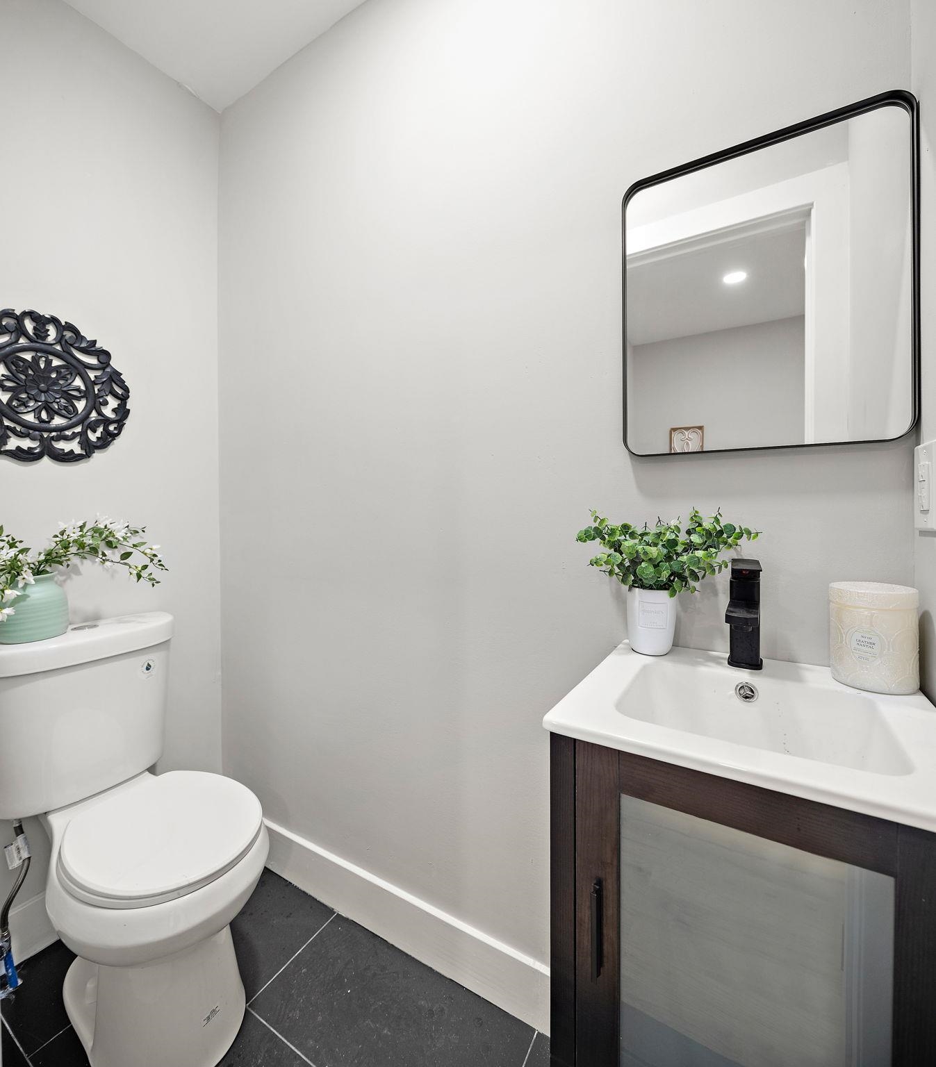 77 Boyd Avenue Jersey City, NJ 07304 - Photo 19 of 26 a bathroom with a toilet a sink and mirror