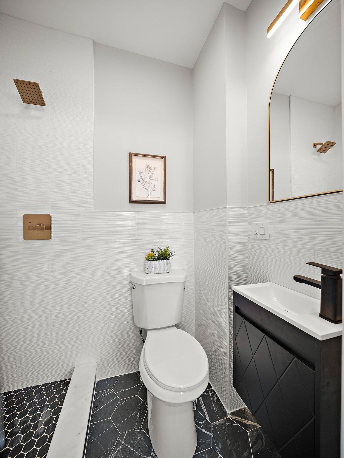 77 Boyd Avenue Jersey City, NJ 07304 - Photo 20 of 26 a bathroom with a toilet a sink and vanity