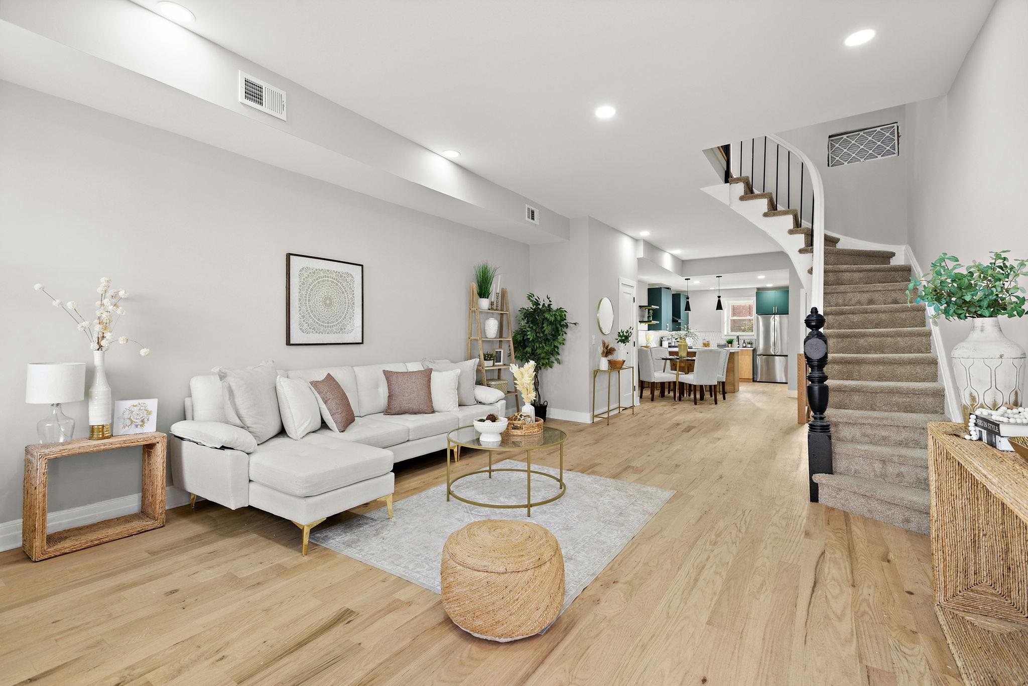 77 Boyd Avenue Jersey City, NJ 07304 - Photo 2 of 26 a living room with furniture and a wooden floor
