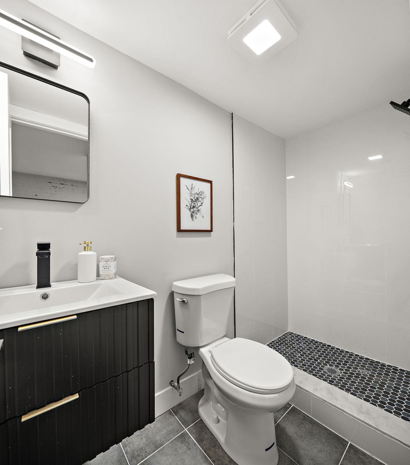 77 Boyd Avenue Jersey City, NJ 07304 - Photo 22 of 26 a bathroom with a toilet a sink and mirror