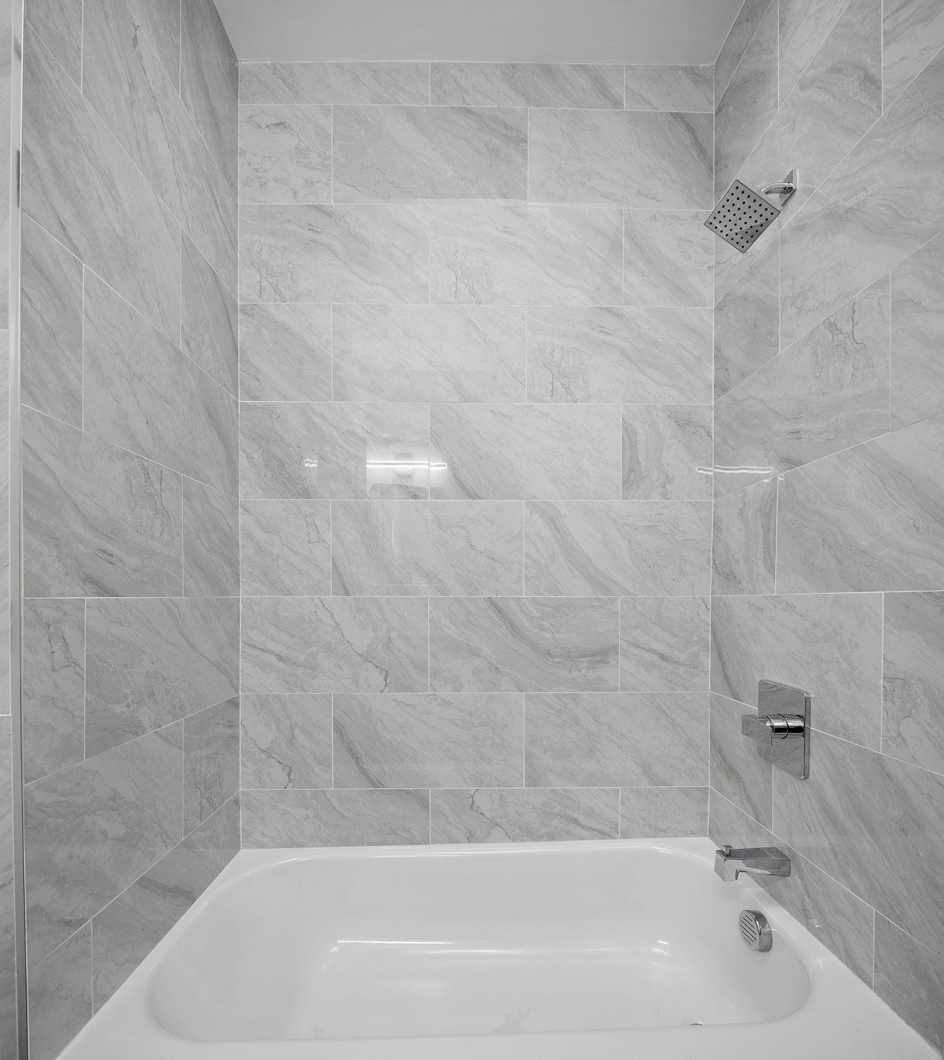 77 Boyd Avenue Jersey City, NJ 07304 - Photo 23 of 26 a bathroom with a bathtub