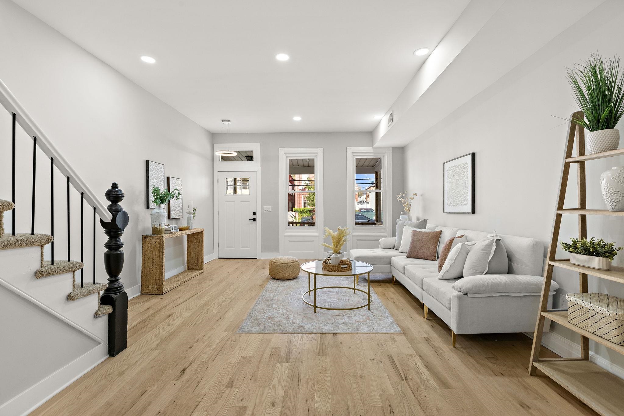 77 Boyd Avenue Jersey City, NJ 07304 - Photo 3 of 26 a living room with furniture and a wooden floor