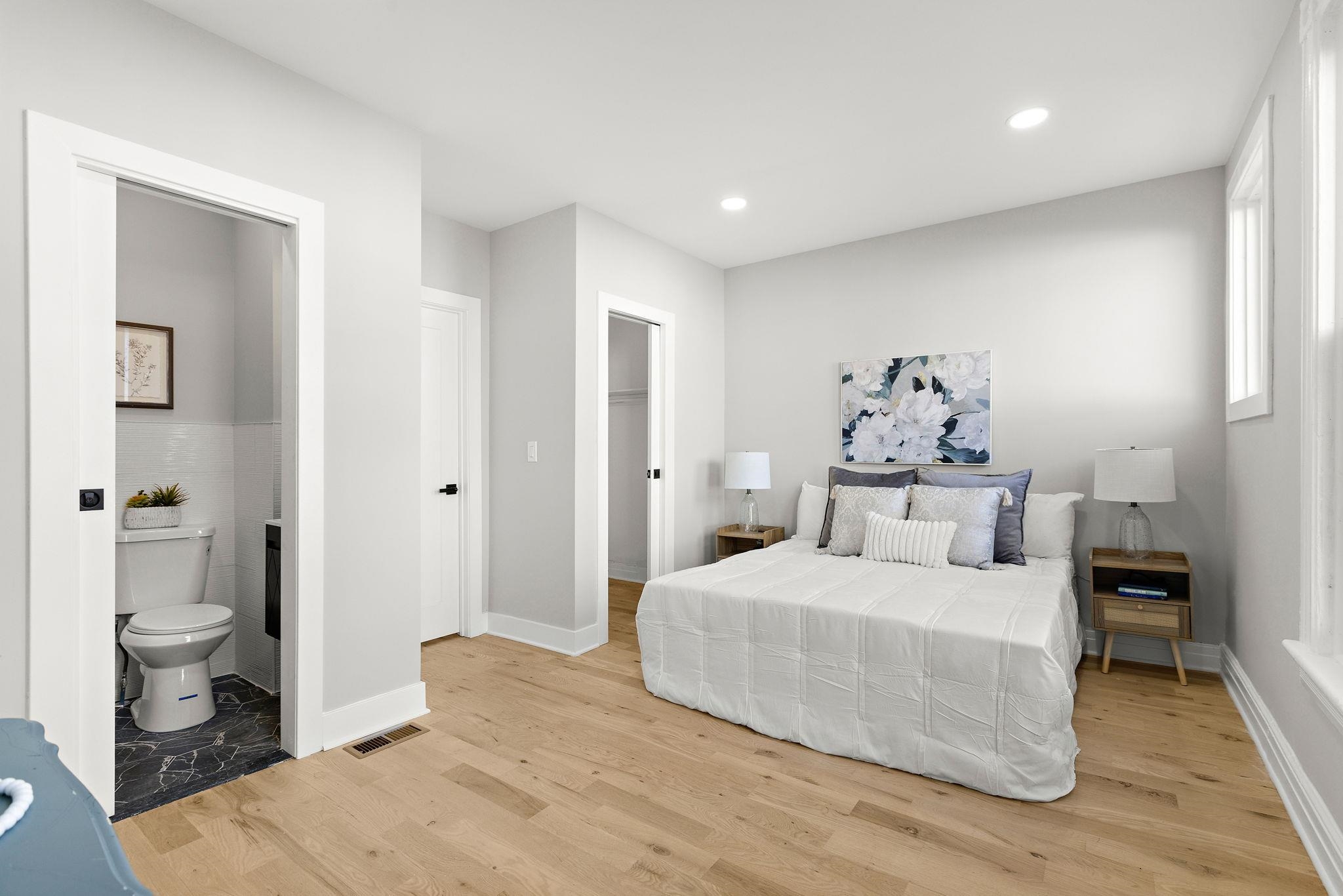 77 Boyd Avenue Jersey City, NJ 07304 - Photo 9 of 26 a bedroom with a large bed and a wooden floor