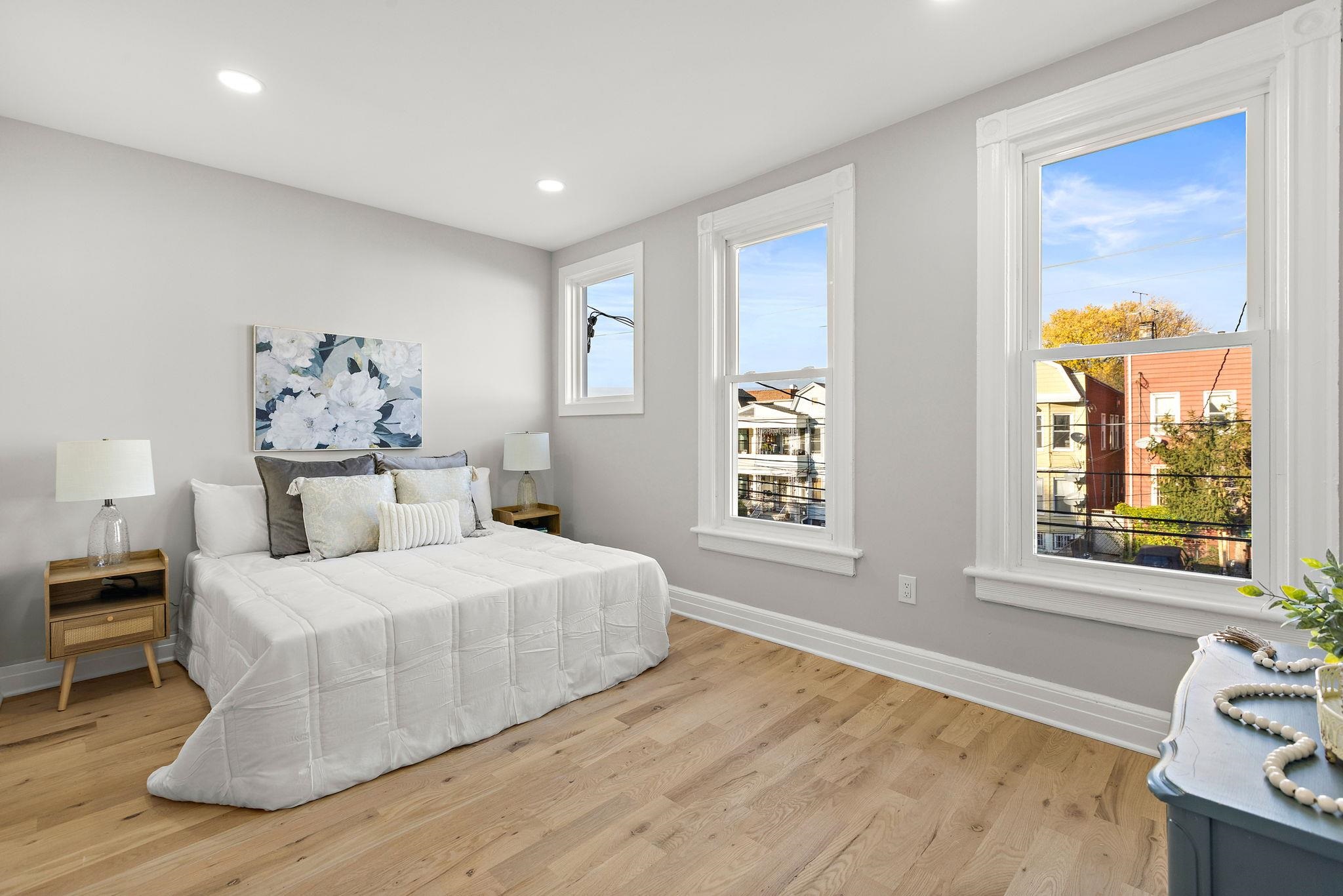 77 Boyd Avenue Jersey City, NJ 07304 - Photo 10 of 26 a bedroom with a bed and a window