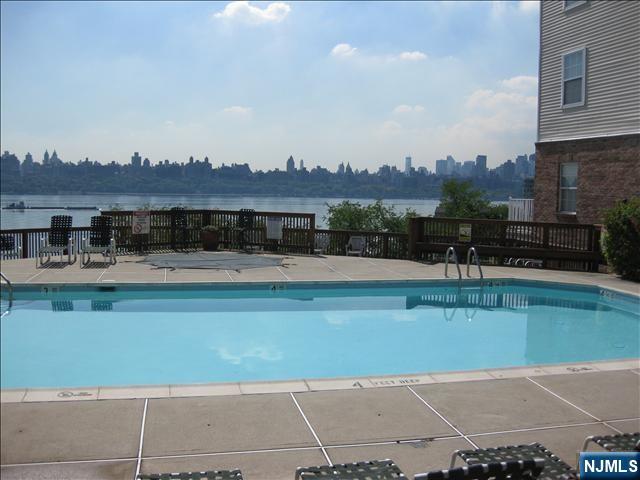 34 Bergen Ridge Road, Unit 2 North Bergen, NJ 07047 - Photo 39 of 41 a view of a swimming pool with a table and chairs