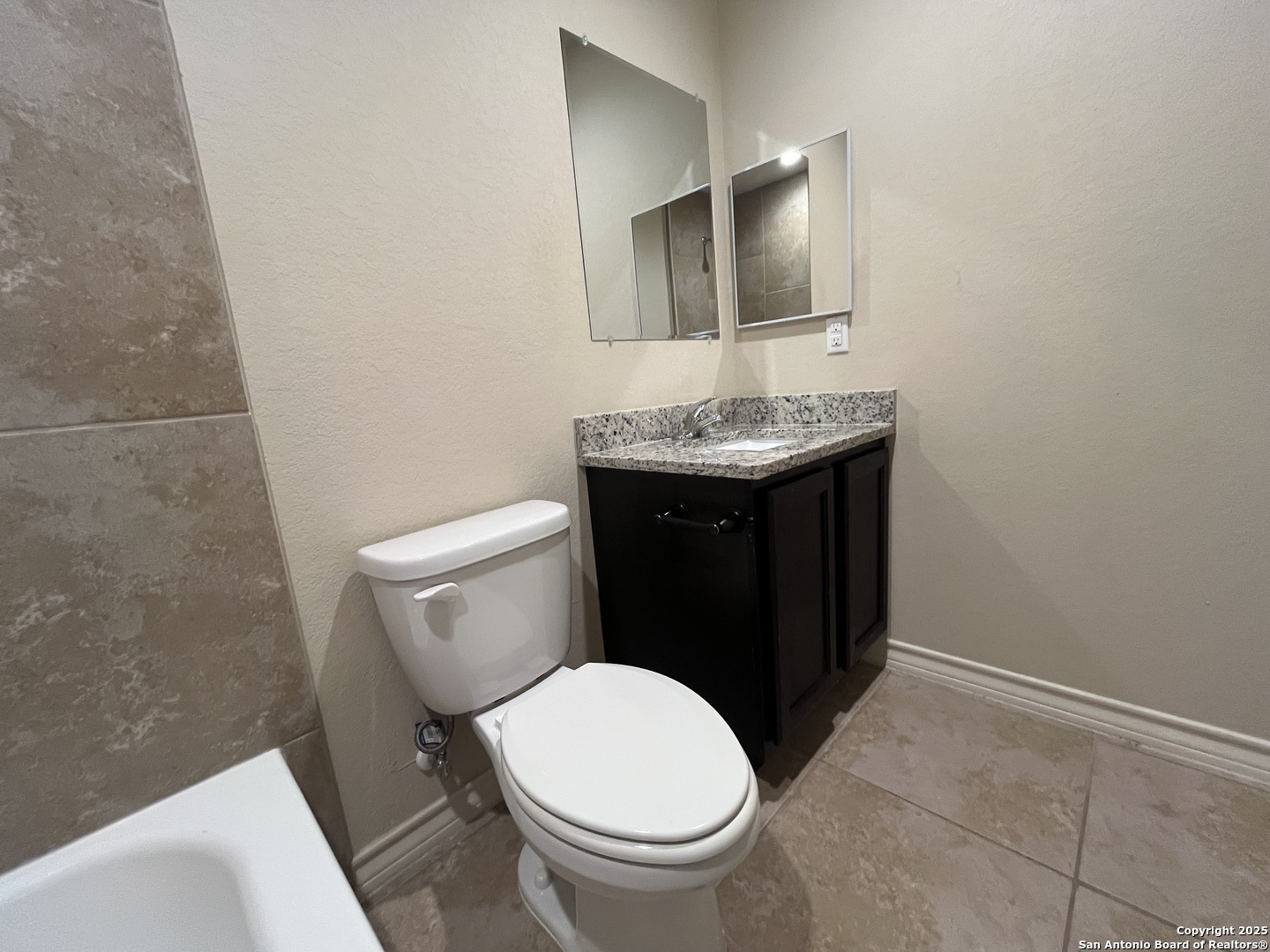 6530 Marcel Way, Unit 103 San Antonio, TX 78233 - Photo 29 of 31 a bathroom with a toilet and a sink