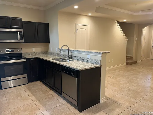 a kitchen with a sink and cabinets