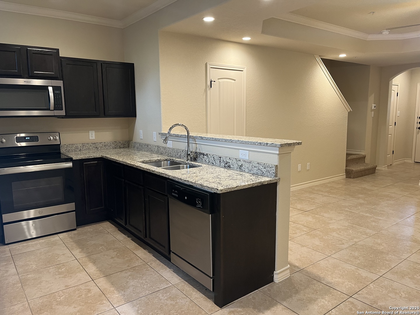 6530 Marcel Way, Unit 103 San Antonio, TX 78233 - Photo 9 of 31 a kitchen with a sink and cabinets