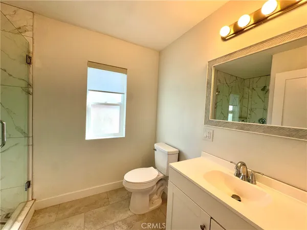 a bathroom with a sink mirror and toilet