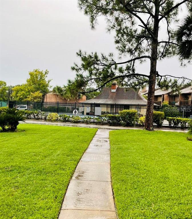 5084 Downing Street, Unit 2 Orlando, FL 32839 - Photo 7 of 7 a view of yard with swimming pool and green space