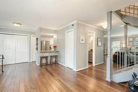 a open kitchen with white cabinets and stainless steel appliances
