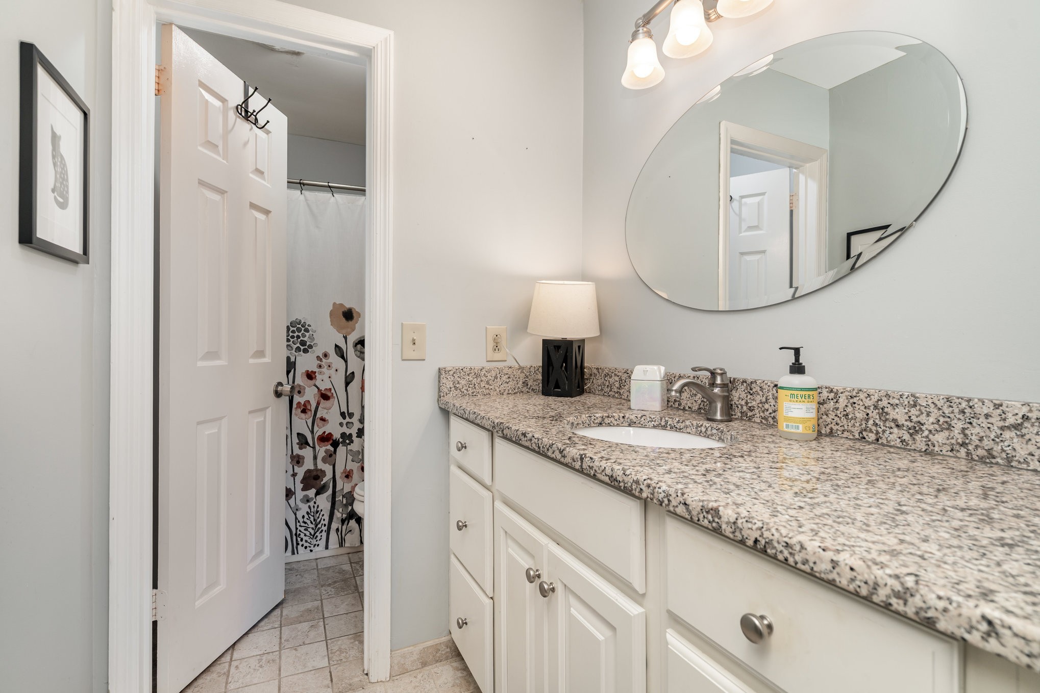 4001 Anderson Road, Unit B124 Nashville, TN 37217 - Photo 21 of 36 a bathroom with a granite countertop sink and a mirror