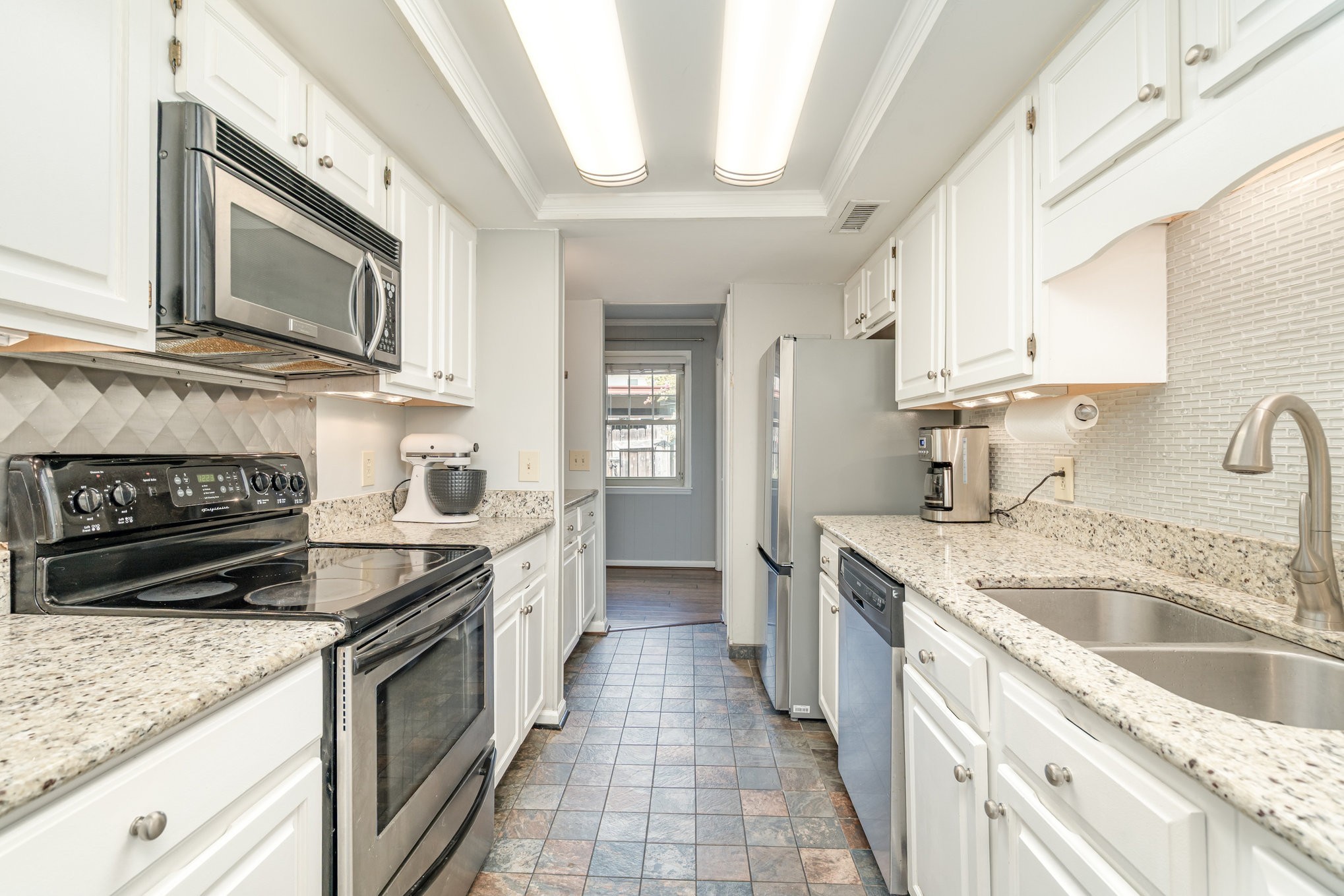 4001 Anderson Road, Unit B124 Nashville, TN 37217 - Photo 10 of 36 a kitchen with stainless steel appliances granite countertop a sink stove and cabinets