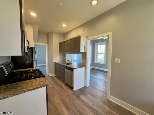a kitchen with a refrigerator and a stove top oven