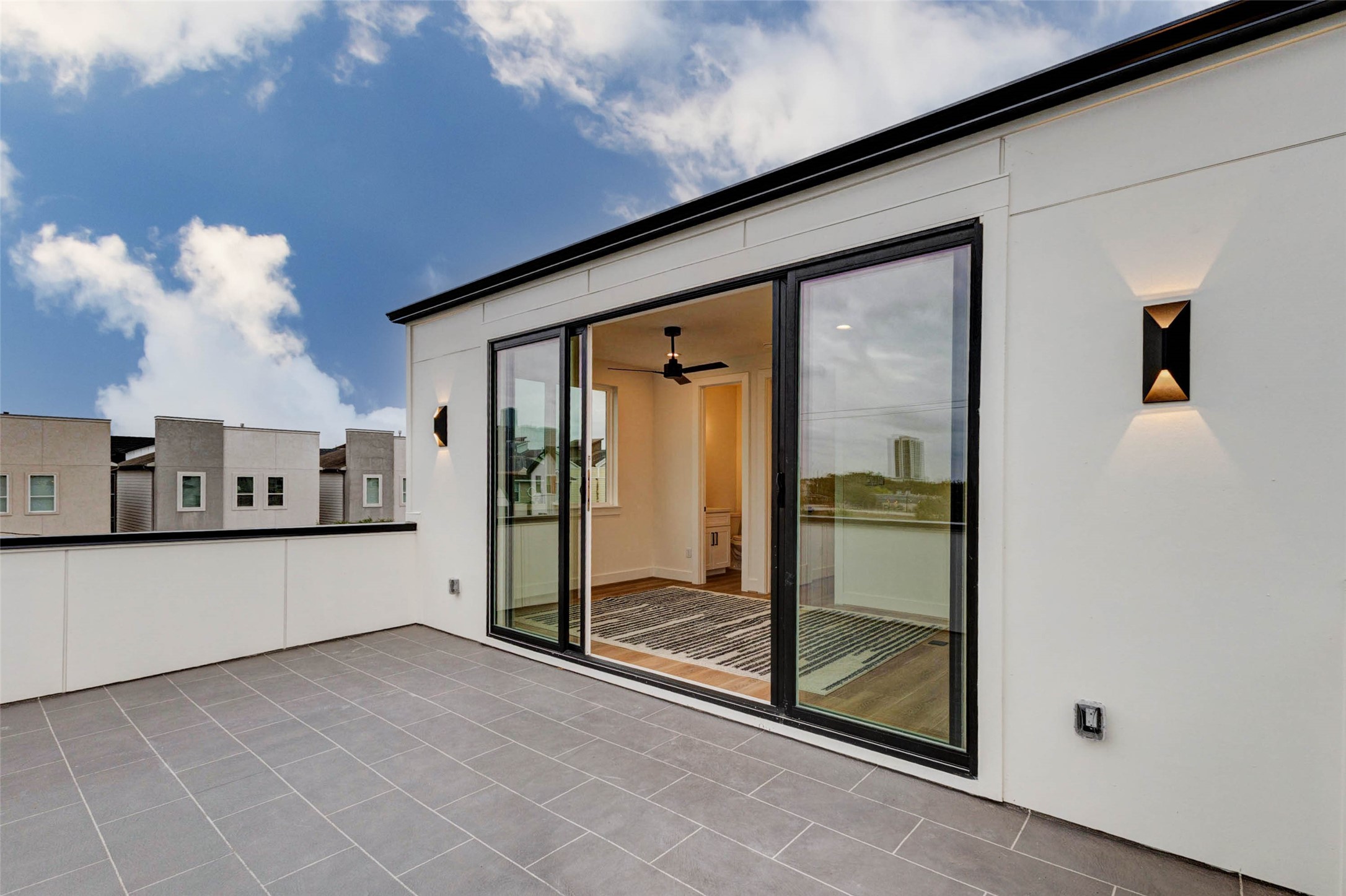 3309 St Emanuel Street Houston, TX 77004 - Photo 45 of 47 Enjoy stunning rooftop views through large, soundproof sliding glass doors. Spacious area perfect for entertaining, featuring fireproof flooring ideal for grilling.