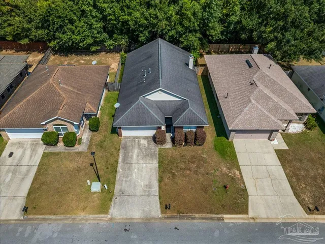 an aerial view of a house with a yard