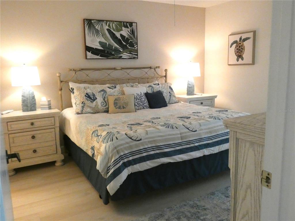 9300 Clubside Circle, Unit 1307 Sarasota, FL 34238 - Photo 13 of 40 a bedroom with a bed and painting on the wall